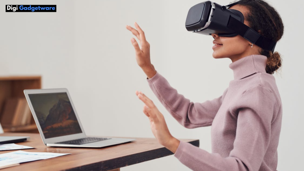 women with VR headset sitting infront of laptop