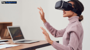 women with VR headset sitting infront of laptop